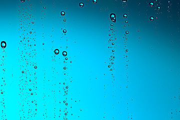 Obraz na płótnie Canvas fresh drops background blue glass / wet rainy background, water drops transparent glass blue