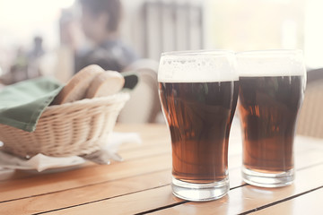 mug of dark beer in the interior of  pub / pint of beer with foam on a served table in  beer restaurant in Czech Republic
