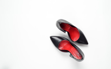 Black woman shoes on white background. Flat lay, top view trendy fashion feminine background. Beauty blog concept.