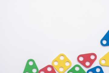 On a white background in a chaotic manner are large multi-colored children's figures. copy space.