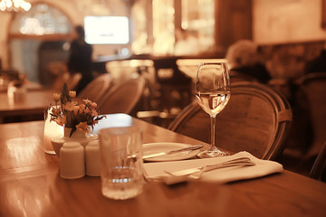 glass of white wine in the restaurant / white wine in the interior of the restaurant a table with glasses of wine, a romantic summer