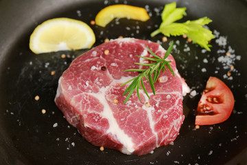 raw meat in pot while making steak 