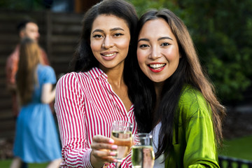 Close-up smiley young girls with champagne glasses
