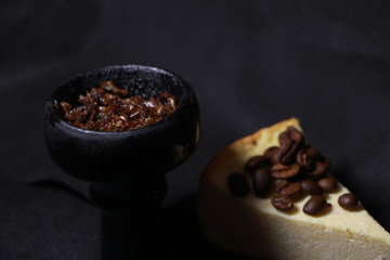 bowl with tobacco for hookah. fruits on a black background