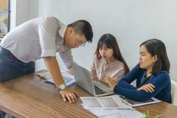 Asian business people discuss about financial report in the office