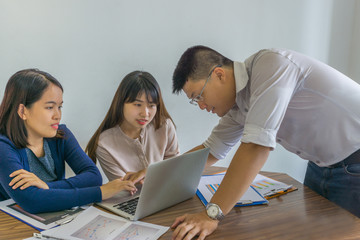 Group of business people discuss about financial number on laptop