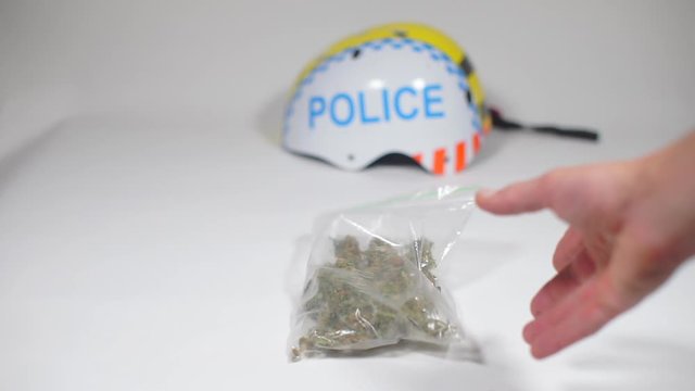 policeman throws a cannabis bag on the table