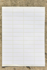 Naklejka premium White Paper sticker label sheet on concrete background. 