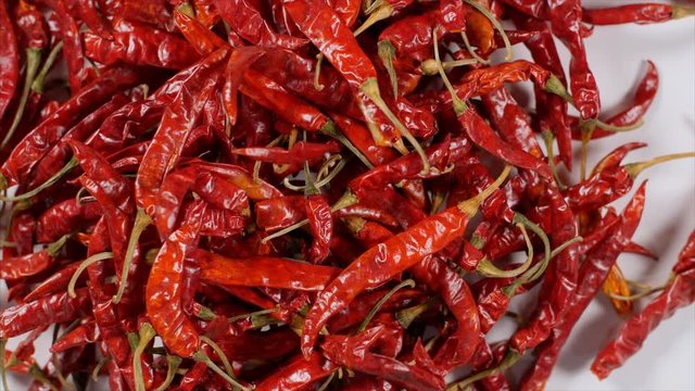 Top view of bunch of dried red chilies - Lal Mirch falling down  on white background. 