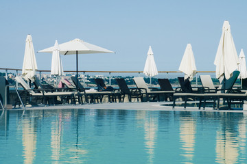 Fototapeta premium Weekend vibes and summertime sunbathing near the swimming pool 