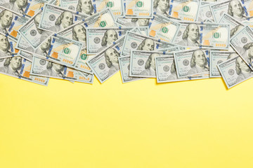 One hundred dollar banknotes on colored background top view, with empty place for your text business money concept. One hundred dollar background.