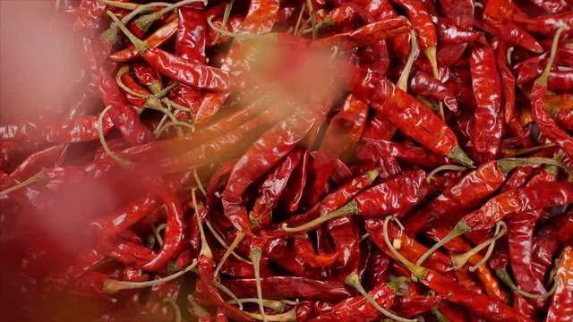 Top view of dried red chilies (Lal Mirch) - Hot Indian Spice falling in slow motion. 