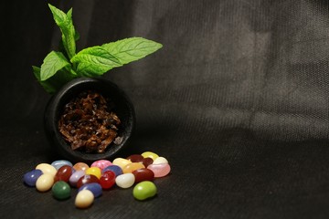 bowl with tobacco for hookah. berries on a black background
