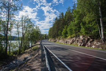 The road along the lake. Ladoga skerries, picturesque asphalt road along the lake