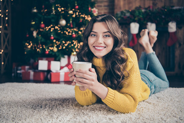 Photo of cheerful charming gorgeous nice cute girl friend wearing yellow sweater jeans denim lying on carpet floor smelling holding sweet cacao