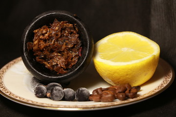 bowl with tobacco for hookah. berries on a black background