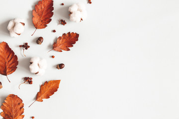 Autumn composition. Frame made of flowers, dried leaves on gray background. Autumn, fall, thanksgiving day concept. Flat lay, top view, copy space
