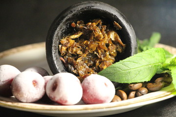 bowl with tobacco for hookah. berries on a black background