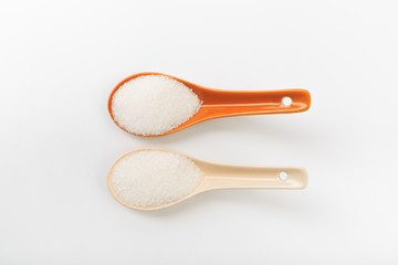 Spoons  of fine granulated sugar isolated on white  - Image