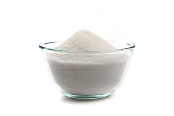 Sugar in glass bowl isolated on white background