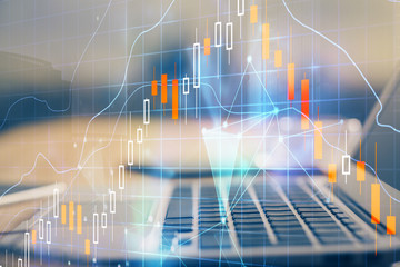 Financial graph colorful drawing and table with computer on background. Double exposure. Concept of international markets.