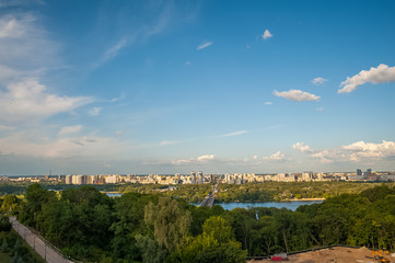Obraz premium View of the city of Kiev, the Dnieper River. City panorama with a place across the river, park, summer day.