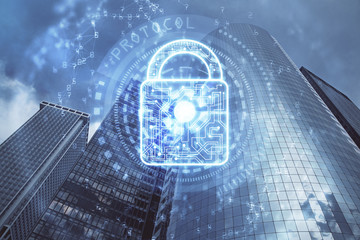 Lock icon hologram on city view with skyscrapers background multi exposure. Data security concept.