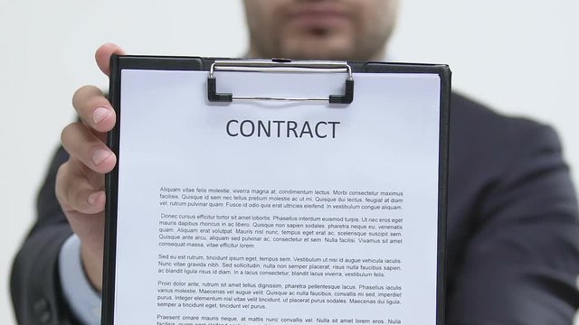 Businessman showing contract at camera, development and cooperation, company