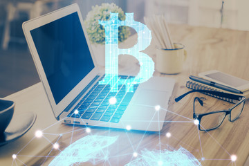 Double exposure of blockchain and crypto economy theme hologram and table with computer background....