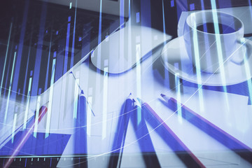Fototapeta premium Stock market chart hologram drawn on personal computer background. Multi exposure. Concept of investment.