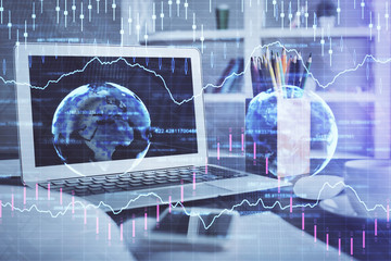 Forex market graph hologram and personal computer on background. Multi exposure. Concept of investment.