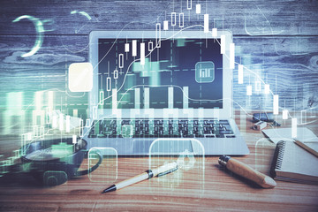 Double exposure of graph and financial info and work space with computer background. Concept of...