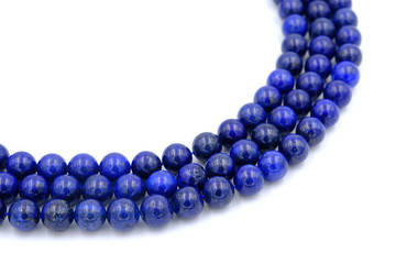 Blue lapis lazuli natural stone round shape bead isolated on white background