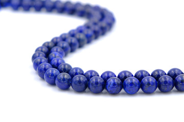 Blue lapis lazuli natural stone round shape bead isolated on white background
