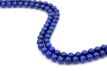 Blue lapis lazuli natural stone round shape bead isolated on white background