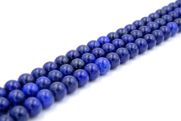 Blue lapis lazuli natural stone round shape bead isolated on white background