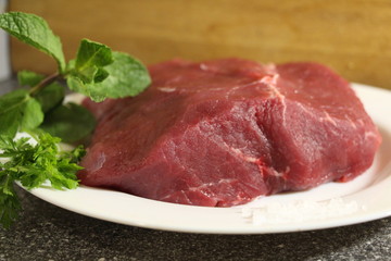 raw beef steak on a plate
