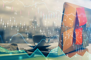 Financial graph colorful drawing and table with computer on background. Double exposure. Concept of...
