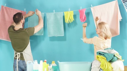 Mad couple spending funny time in laundry room. Lifestyle, party