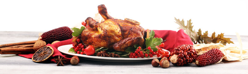 Baked turkey or chicken. The Christmas table is served with a turkey, decorated with fruits, salad and nuts. Fried chicken, table. Christmas
