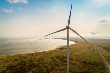 Aerial view of wind turbines on a sea shore.