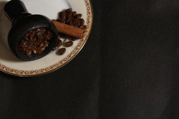 bowl with tobacco for hookah. berries on a black background