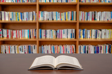 A reading or education concept. Books are spread out on the desk in the public library.