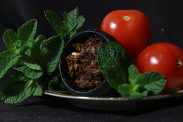 bowl with tobacco for hookah. berries on a black background