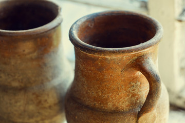 rustic milk dishes on the window