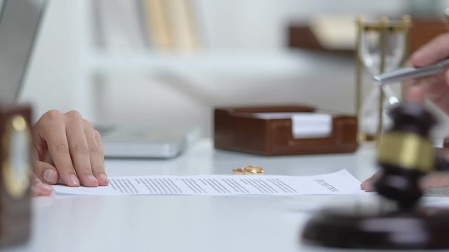 Lawyer explaining woman marriage contract statement before signing document