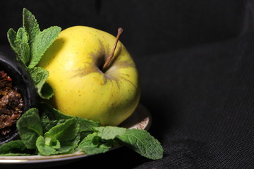 bowl with tobacco for hookah on a dark background. berries on a black table. shiisha smoking