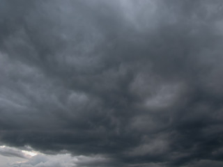 Thick and dark rain clouds in the sky. Sun clearance.