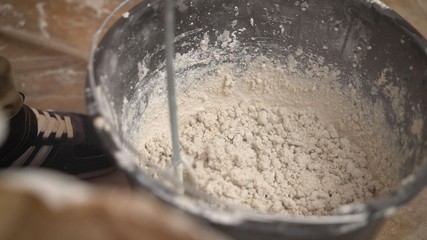The solution is mixed with a construction mixer. Mix the solution in a bucket. Manual mixing of cement mortar with a spade, on a sheet of iron and loading into a bucket