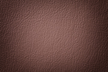 Dark brown leather texture background, closeup. Umber cracked backdrop from wrinkle skin